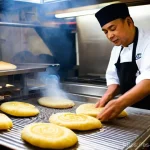 말레이시아 로티차나이 카레 조합 - **Prompt 1: The Art of Roti Canai Preparation**
"A skilled Malaysian chef, dressed in a clean, m...